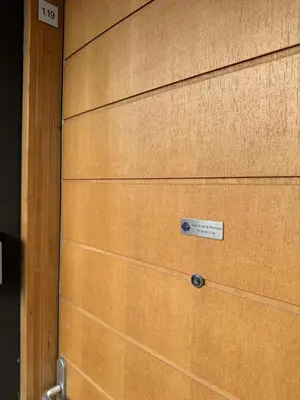 a wooden garage door with a sign on it at 014 Studio Provençal - Proche d'Aix en Provence in Éguilles