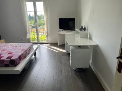 a bedroom with a bed and a desk and a television at Mas Provençale entre Avignon et St Remy de Provence in Noves