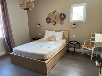 a bedroom with a bed with a wooden frame at Mas Provençale entre Avignon et St Remy de Provence in Noves
