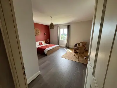 a bedroom with a bed with a red bedspread at Mas Provençale entre Avignon et St Remy de Provence in Noves