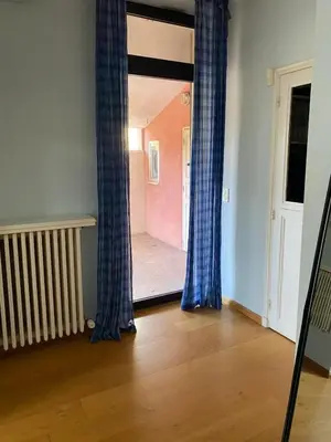 an empty room with blue curtains and a doorway at Villa élégante à Cavaillon avec piscine in Cavaillon