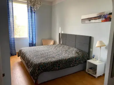 a bedroom with a large bed and a window at Villa élégante à Cavaillon avec piscine in Cavaillon