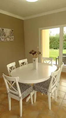 a white dining room table and chairs with a vase on it at Villa spacieuse à Cavaillon avec piscine privée in Cavaillon