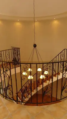a wrought iron chandelier in a room at Villa spacieuse à Cavaillon avec piscine privée in Cavaillon