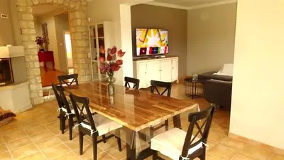 a dining room with a wooden table and chairs at Villa spacieuse à Cavaillon avec piscine privée in Cavaillon