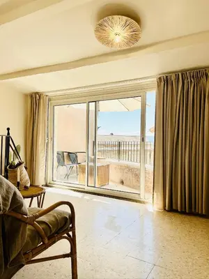 a living room with a couch and a large window at Maison Joucas in Joucas