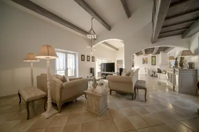 a living room with couches and chairs and a tv at La maison de Inna in Bonnieux