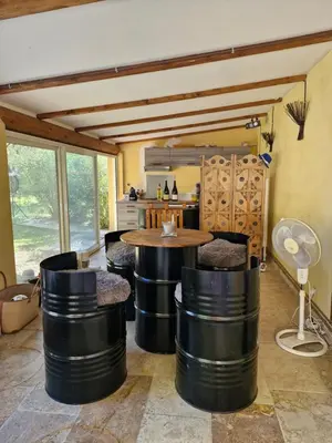 a living room with a table and some chairs at Maison avec piscine privée, sauna et activités - Rendez-vous en Provence in Althen-des-Paluds