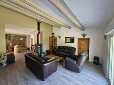 a living room with two leather couches and a table at Maison avec piscine privée, sauna et activités - Rendez-vous en Provence in Althen-des-Paluds