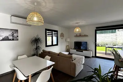 a living room with a couch and a table at Chez Céline - Belle maison climatisée piscine in Carpentras