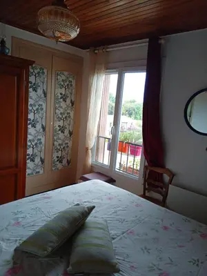 a bedroom with a large bed and a window at T3 campagne Aix-en-Provence in Meyrargues