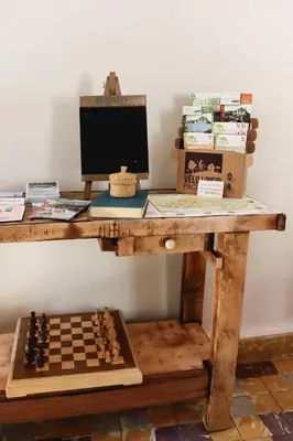a desk with a computer and a chessboard on it at Gîte de l'Escanson un temps pour soi in Robion en Luberon