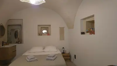 a bedroom with a bed with two towels on it at Petit bonheur in Lauris