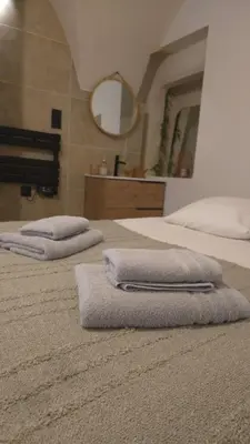 a bedroom with two beds with towels on them at Petit bonheur in Lauris