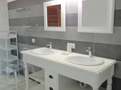a bathroom with two sinks and a mirror at Domaine Les Rivales in Cavaillon