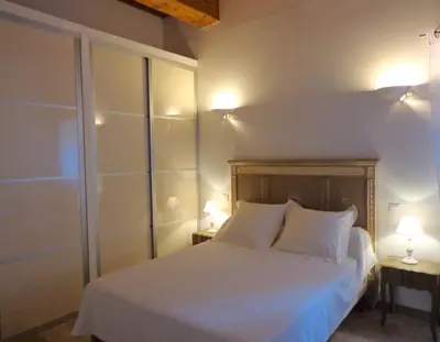 a bedroom with a bed with two lamps on two tables at Domaine Les Rivales in Cavaillon