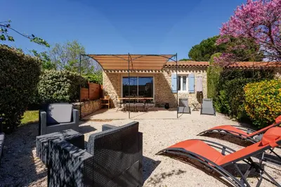 a house with a pavilion with a table and chairs at Lou Karo - Piscine partagée - Parking privé in Gordes