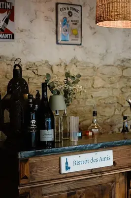 a table with bottles of wine and a sign on it at LE MAS DE LA TERRE - Chambres d'hôtes in LʼIsle-sur-la-Sorgue