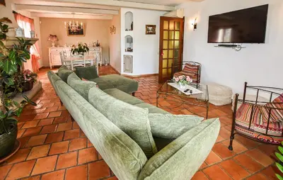 a living room with several couches and a television at Beautiful Home In La Bastide-Des-Jourdan in La Bastide-des-Jourdans