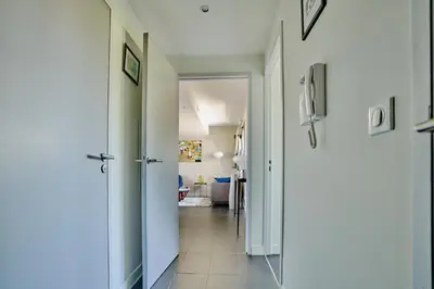 a hallway with a hallway leading to a living room at Sérénité au fil de l'eau Appartement de standing in LʼIsle-sur-la-Sorgue