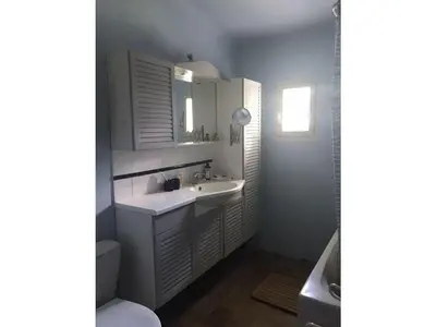 a white bathroom with a sink and a toilet at Oud Wijnhuis Mas in Sénas