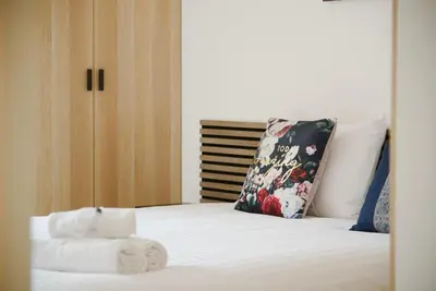 a bed with a pillow and two towels on it at appartement idéalement situé sur aix en provence in Aix-en-Provence