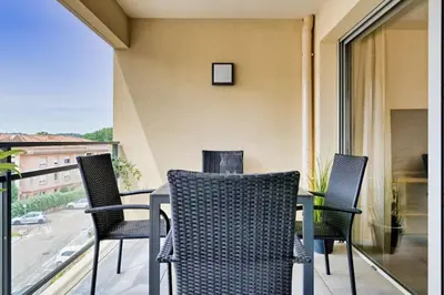 a table and chairs on a balcony with a view at appartement idéalement situé sur aix en provence in Aix-en-Provence