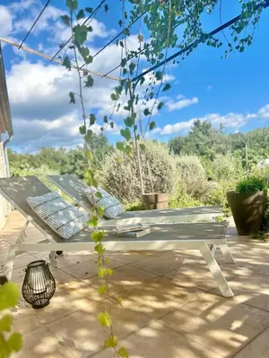 a white picnic bench sitting on a patio at La villa Louca in Saint-Saturnin-les-Apt