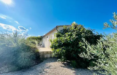 a house with a large bush in front of it at La villa Louca in Saint-Saturnin-les-Apt
