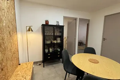 a dining room with a table and chairs and a cabinet at Très bel appartement climatisé - Chez Tom et Anna in Bédoin