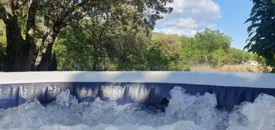 a bunch of water in a wall with trees in the background at Odette du Colorado, vue sur le colorado, jacuzzi, boisé in Rustrel