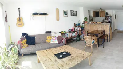 a living room with a couch and a table at Charmante maison de vacances en Luberon in Beaumettes