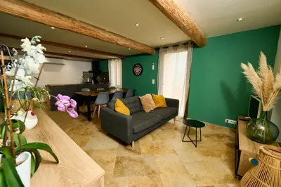 a living room with a couch and a table at Maison avec jardin in Pernes-les-Fontaines