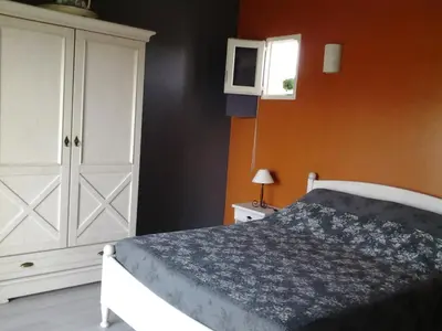 a bedroom with a bed and a white cabinet at Le Cabanon d'Amandine et Gabriel in Blauvac