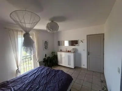 a bedroom with a bed and a window at Villa Reillanne Luberon in Reillanne