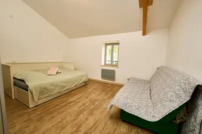 a bedroom with a bed and a chair in it at Gîte entier en Campagne in Pernes-les-Fontaines