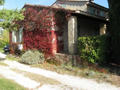 a house with red ivy on the side of it at Clos Sainte-Garde in Saint-Didier