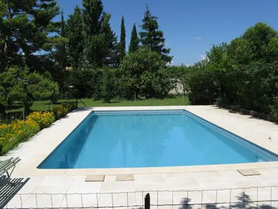 a swimming pool in a garden with trees and flowers at Clos Sainte-Garde in Saint-Didier