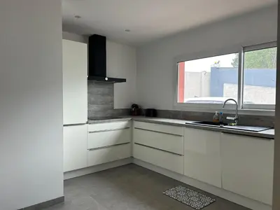 a white kitchen with a sink and a window at Pitchoun in Velaux