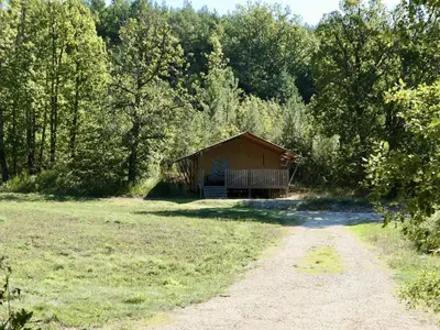 a cabin in the middle of a field with a dirt road at La Grisonne Chalet 2 in Revest-du-Bion