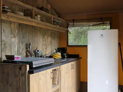 a kitchen with wooden cabinets and a white refrigerator at La Grisonne Chalet 2 in Revest-du-Bion