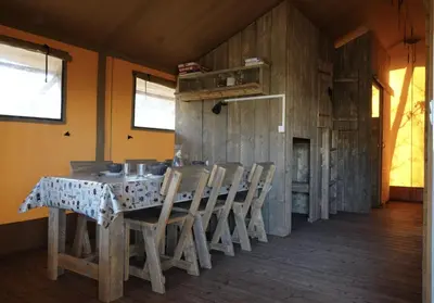 a dining room with a table and chairs at La Grisonne Chalet 1 in Revest-du-Bion