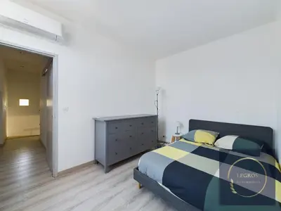 a bedroom with a bed and a dresser in it at La terrasse du pêcheur in LʼIsle-sur-la-Sorgue
