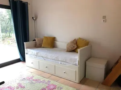 a white couch with pillows on it in a room at Proche Aix-en-Provence maison avec piscine - 10 personnes in Rognes