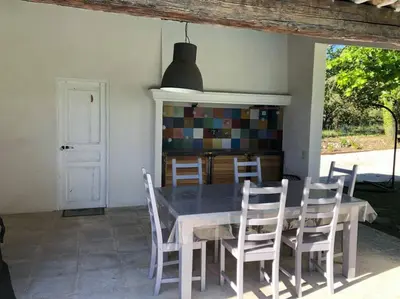 a dining room with a table and chairs at Proche Aix-en-Provence maison avec piscine - 10 personnes in Rognes