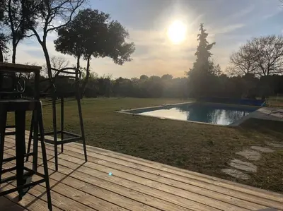 a deck with a view of a swimming pool at Proche Aix-en-Provence maison avec piscine - 10 personnes in Rognes