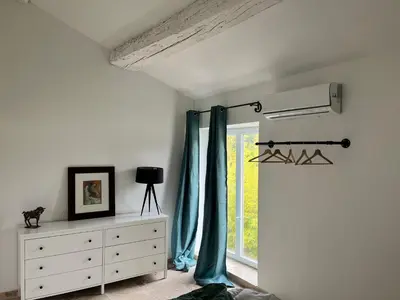 a bedroom with a curtain and a dresser and a window at Maison : L'Appart des Anges 10 personnes in Althen-des-Paluds