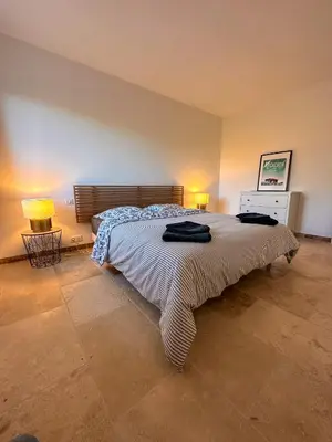 a bedroom with a large bed and two lamps at Maison : L'Appart des Anges 10 personnes in Althen-des-Paluds