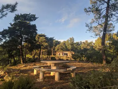 a picnic table in the middle of a park at Villa Les Gourdeaux in Roussillon