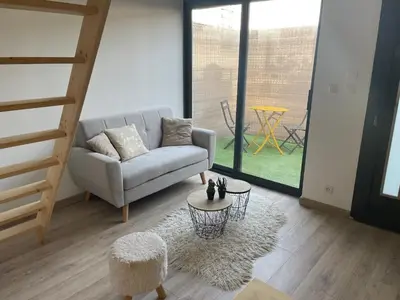 a living room with a couch and a table at Studio cosy avec mezzanine in Salon-de-Provence
